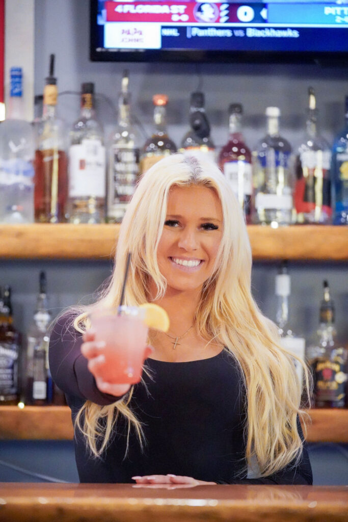 Erik's Church Bar & Brill Female Bartender Holding Drink